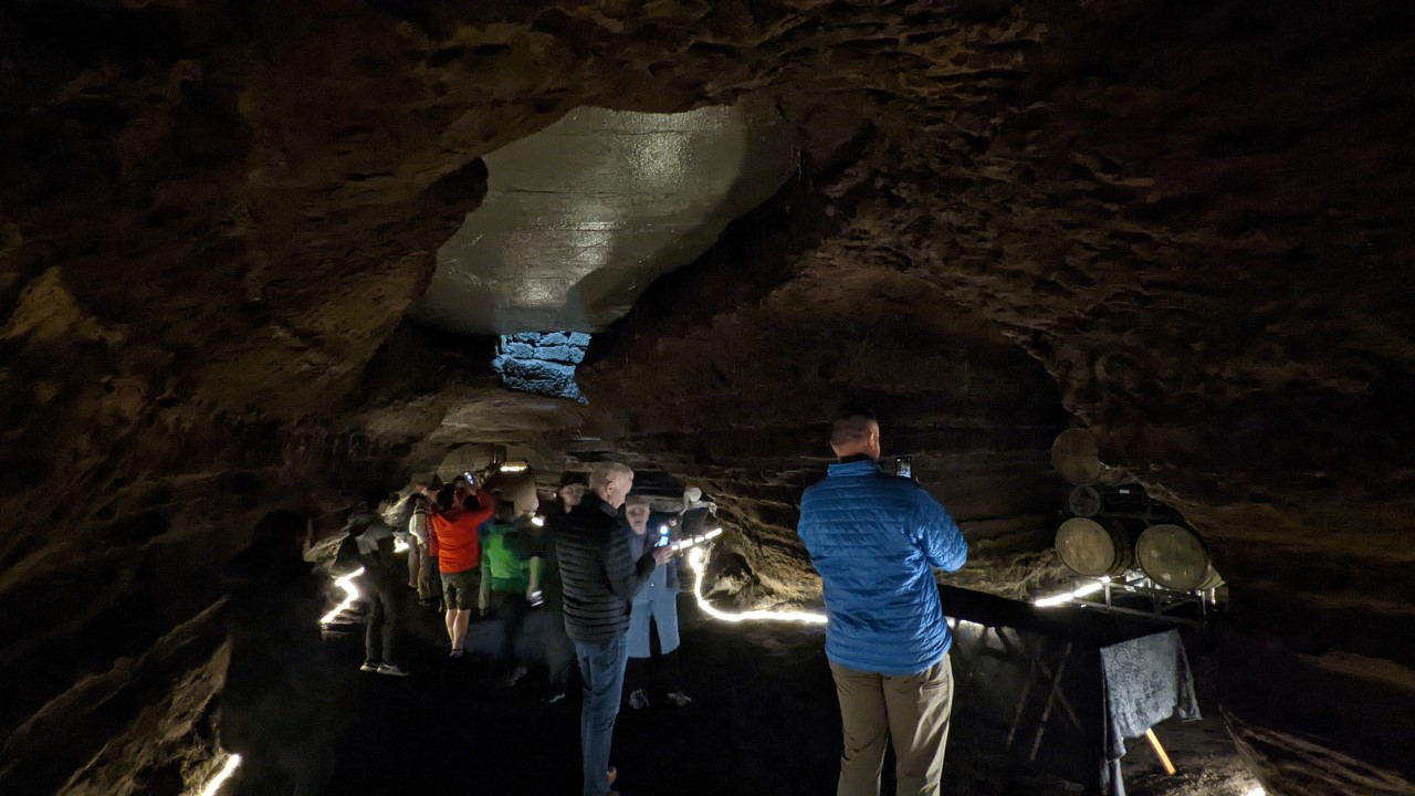 Eine Touristenpruppe besichtigt die Caves of Hella in Island von innen