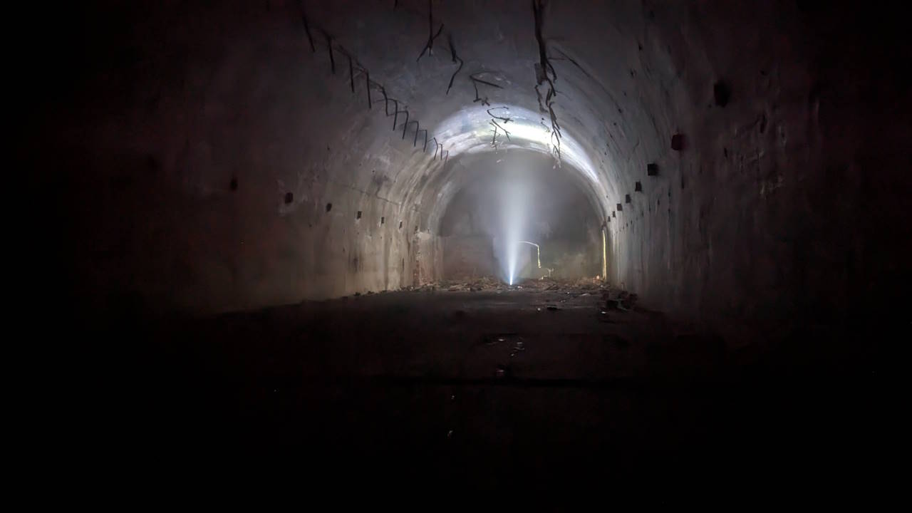 Unterirdischer Bunker in Karosta, der von einer einzelnen Taschenlampe erleuchtet wird. 