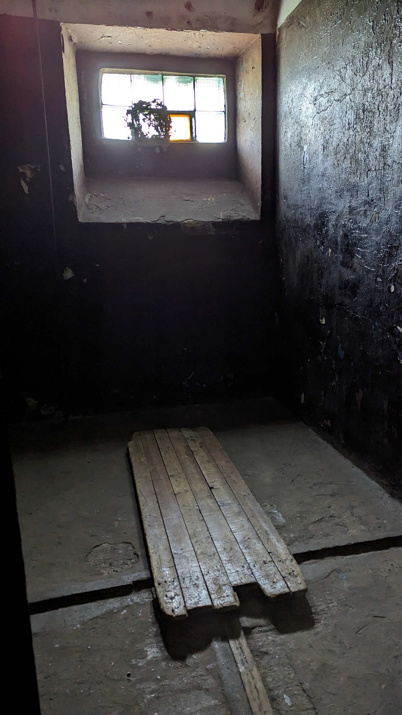 Innenansicht einer Zelle im Gefängnis von Karosta mit Holz Pritsche