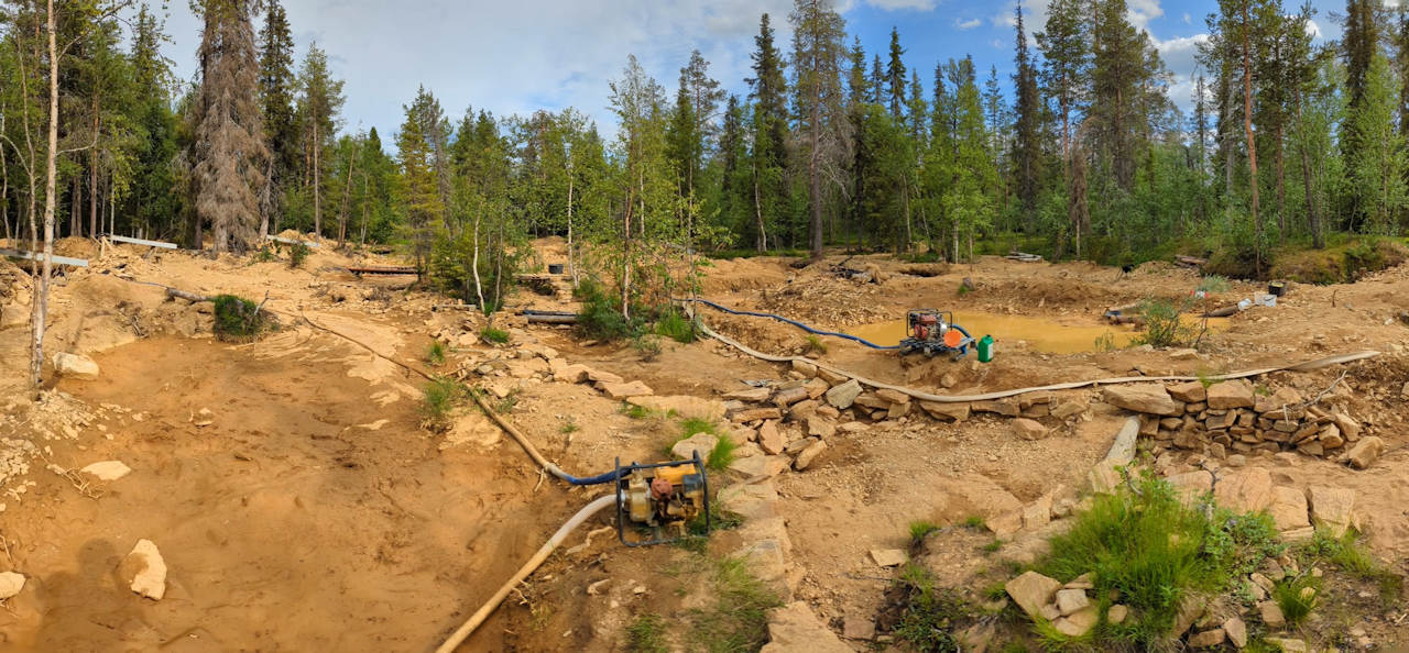 Panoramabild vom Goldfeld in Tankavaara mit ausgehobenen Gruben, Benzinpumpen und Ausrüstung