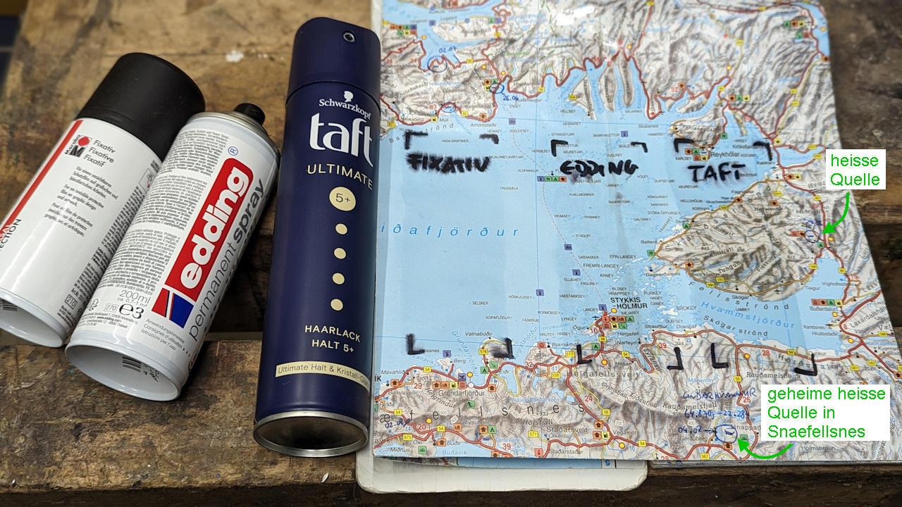 Eine Papier Landkarte wird mit Taft Haarlack, Edding permanent spray und Fixativ behandelt. 