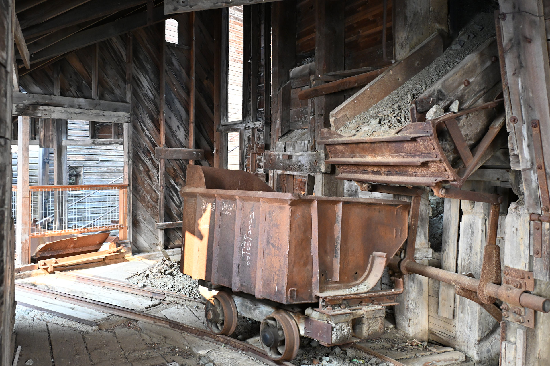 Rostige Lore auf Schienen unter eine Schütt Einrichtung 