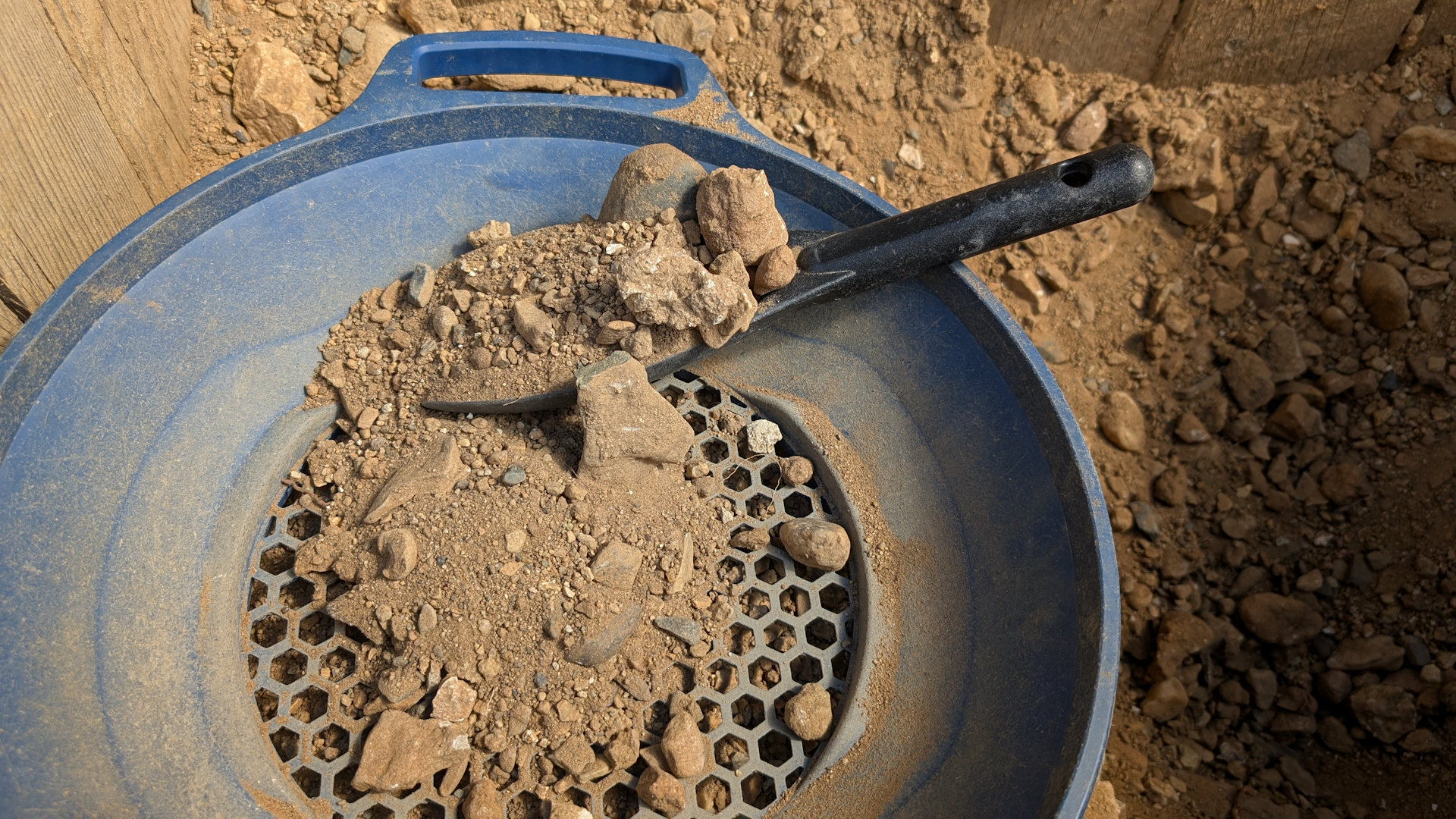Blaues Plastiksieb um Steine von goldhaltigen Sand zu trennen