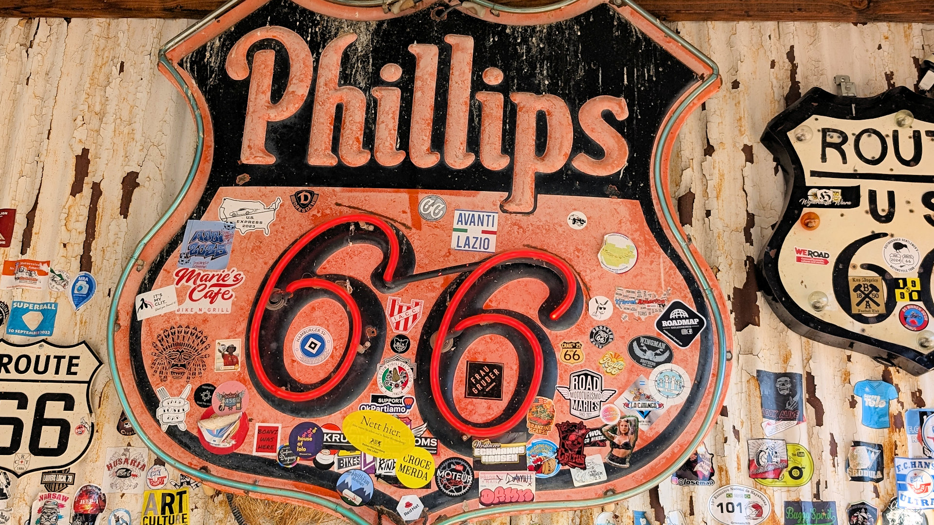 Mit vielen Aufklebern beklebtes Phillips 66 Schild am Rand der Route 66 