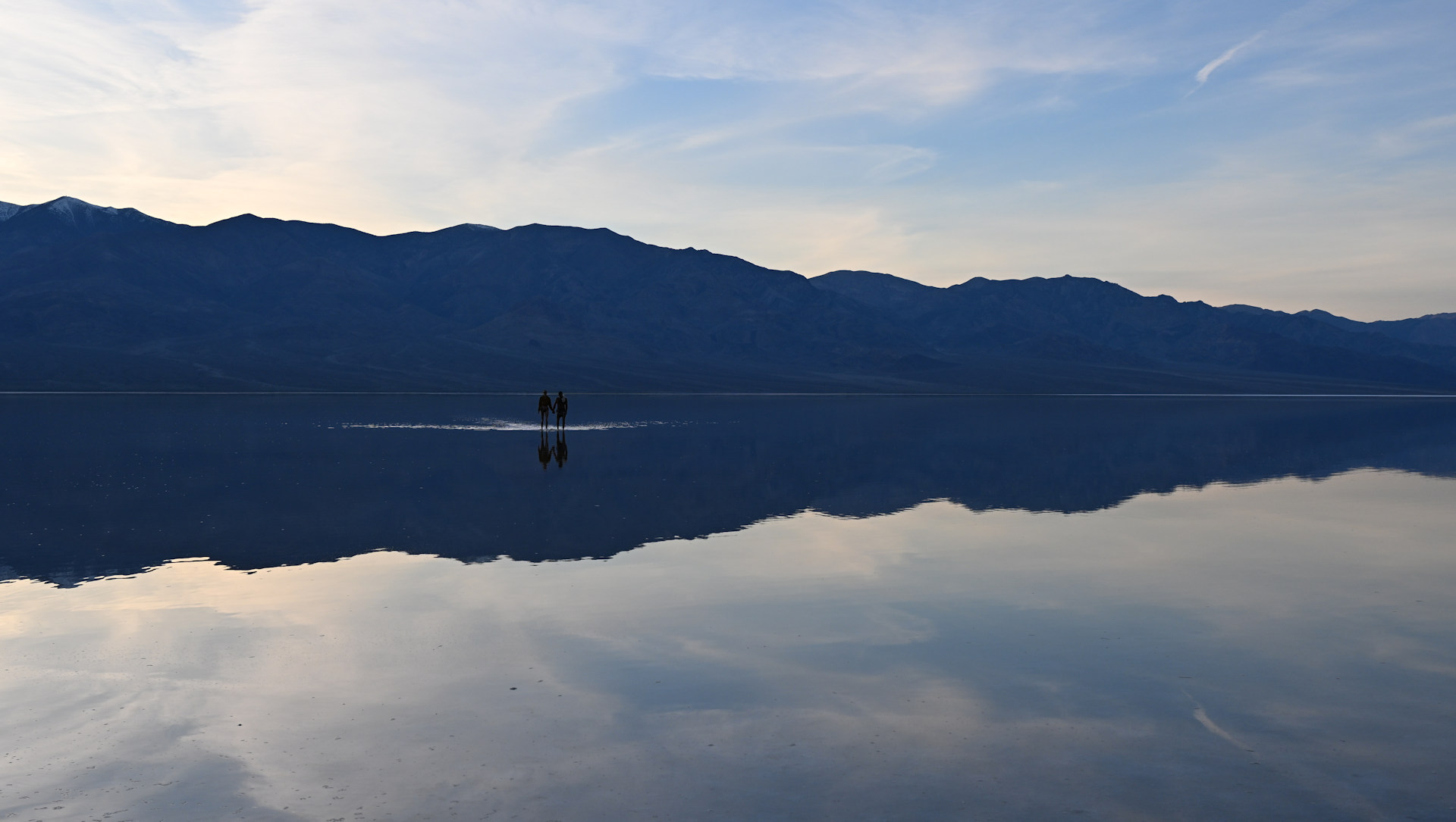 Zwei Spaziergänger sind auf der überschwemmten Ebene vom Bad Water Bassin unterwegs