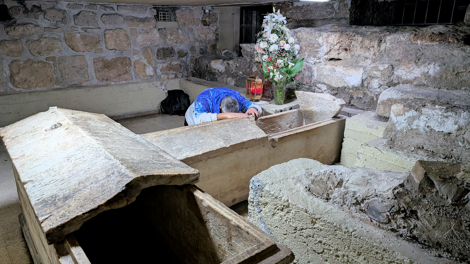 Mann betet in einer Krypta 