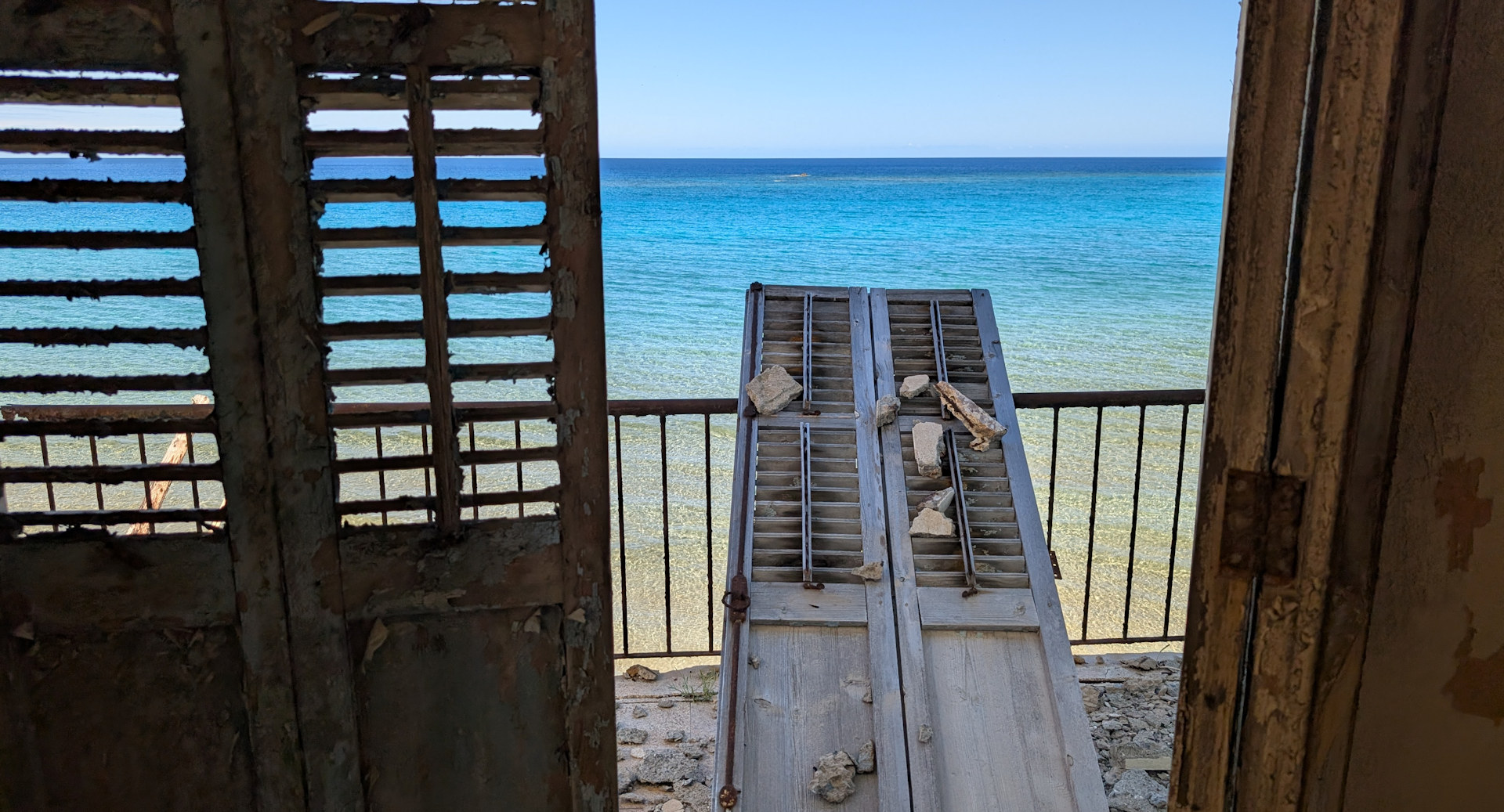 Herausgebrochene Tür von einem Hotelzimmer in Varosia, vor blauem Meer